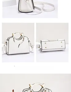 Detail of white leather shell bag featuring unique golden cat-ear handles and studs