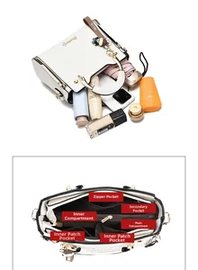 Detail view of large capacity interior compartments and pockets of white leather handbag