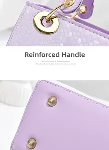 Detail view of reinforced handle joints and gold metal rivets on purple leather bag