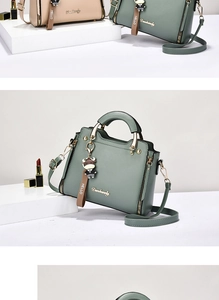 Detail of the sage green PU leather handbag with gold logo and cartoon bull charm
