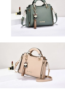Detailed view of beige and dark green leather handbags with stylish cartoon cow charms