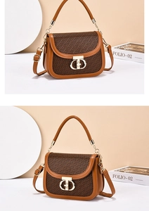 Detail of vintage brown crossbody bag with plaid flap and golden metal chain handle
