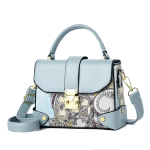 Elegant light blue paisley pattern handbag with gold hardware and top handle strap