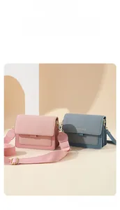 Detail of canvas texture shoulder bags with wide straps and gold hardware finish