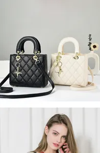 Close-up of quilted leather handbags in black and beige with star charms and round handles
