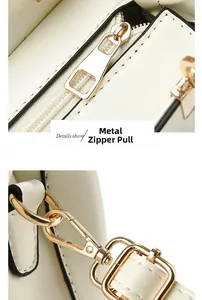 Detailed close-up of golden hardware zipper puller and strap hook on white leather handbag