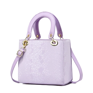Luxury purple snake-textured handbag with gold hardware and removable shoulder strap