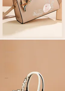 Detail of elegant beige leather handbag with rose embroidery and silk scarf handle