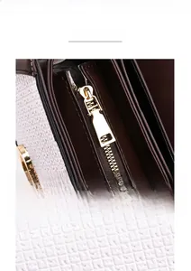 Detail of contrast stitching leather with embossed FF pattern and golden metal zipper