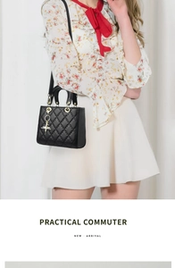 Close-up of black quilted crossbody bag with gold hardware and star pendant accessory