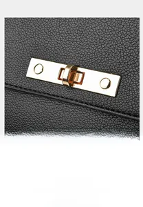 Detail of lychee pattern leather texture with golden twist-lock buckle on handbag