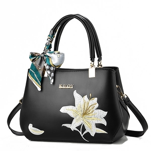 Premium black embroidered handbag with white lilies, gold accents and silk scarf handle