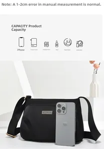 Capacity detail of black nylon crossbody bag showing smartphone size comparison