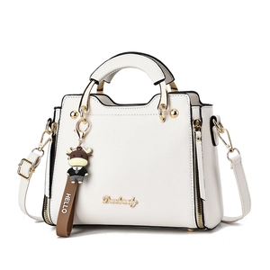 Modern white minimalist tote bag with adjustable strap and cute cow charm pendant