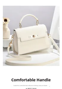 Detail view of the durable handle and precise stitching on the cream leather handbag