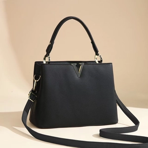 Elegant black lychee grain leather handbag with V-shaped metal hardware and top handle