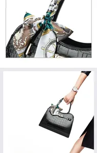 Detail einer Handtasche mit Krokodilmuster, Goldverschluss und dekorativem Seidenschal
