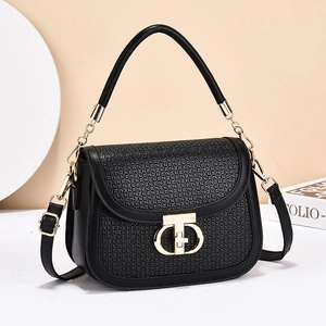 Chic black saddle bag with woven texture, golden ring buckle, and adjustable strap