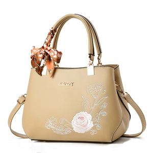 Elegant beige embroidered handbag with floral patterns, top handle, and scarf detail