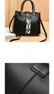 Close-up of black lychee grain leather texture and snakeskin ribbon detail on bag