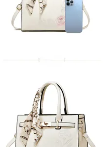 Detail of elegant beige crossbody bag with rose embroidery and chain silk scarf wrap