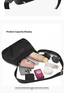 Detailed view of black nylon crossbody bag interior capacity and metal hardware details