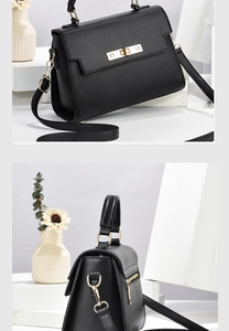 Close-up of black lychee leather bag with gold hardware lock and adjustable shoulder strap