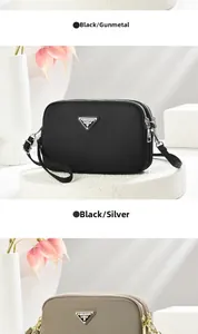 Detail view of stylish nylon camera bags in black and khaki with metallic logo plates