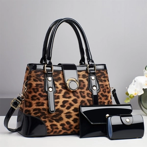 Three-piece leopard print bag set including tote, long wallet, and small pouch with gold hardware
