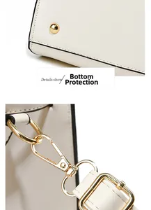Close-up of white leather handbag base studs and gold detachable strap hook detail