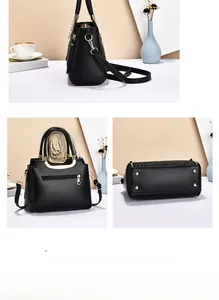 Detailed view of black woven handbag featuring golden hardware and protective bottom studs