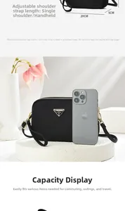 Close-up of black nylon crossbody bag with adjustable strap and size comparison to iPhone