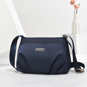Navy blue crossbody nylon bag for women with adjustable strap and golden logo detail