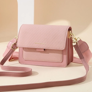 Pink crossbody flap bag with textured woven pattern and wide shoulder strap