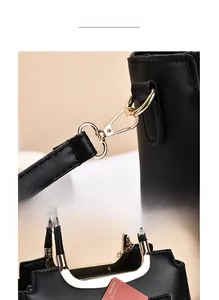 Detail of high-quality gold plating on metal hooks and handle rings of the black woven bag