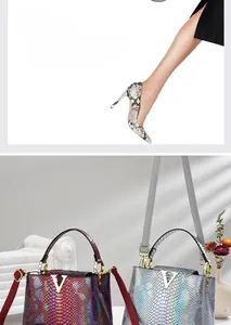 Close-up of crocodile pattern leather texture with metallic V hardware and chain strap