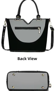 Detailansicht der Handtasche mit goldener Reißverschlusstasche und Metallfüßen am Boden