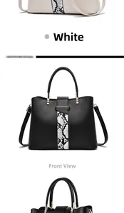 Detail of elegant two-tone handbag with snake skin texture stripe and metallic accents