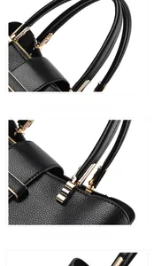 Detail of reinforced handles and gold hardware on black lychee grain leather tote bag