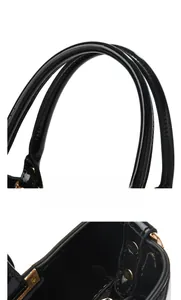 Detail von schwarzer Lacklederhandtasche mit zylindrischen Griffen und Goldnieten
