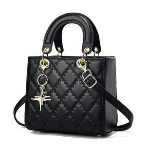 Classic black quilted leather crossbody bag with gold hardware and star charm detail
