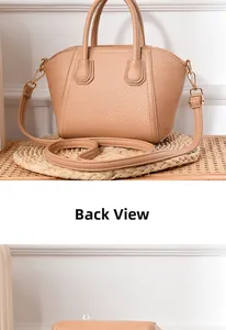 Detail view of khaki shell handbag featuring litchi texture and golden metal hardware