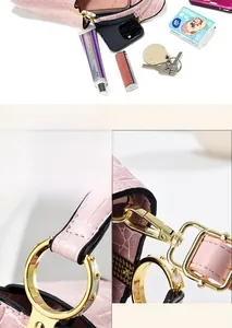Detailed view of pink croc-embossed handbag showing spacious interior and gold hardware