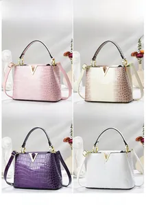 Collage of four crocodile pattern leather handbags in pink, cream, purple, and white colors