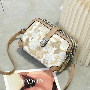 Three-layer crossbody bag with floral embroidery and adjustable leather strap