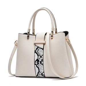 Off-white leather handbag with snakeskin pattern and gold hardware on white background