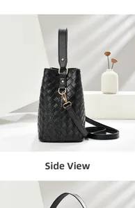 Side view of black woven leather bucket bag with gold hardware on a white pedestal