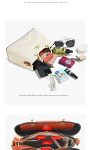 Detail view of large capacity interior with organized compartments for cream and orange handbag