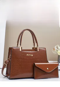 Brown crocodile embossed tote bag with matching pouch and gold hardware accents