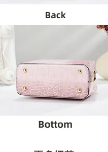 Detailed base of pink crocodile pattern handbag with four protective gold metal feet studs